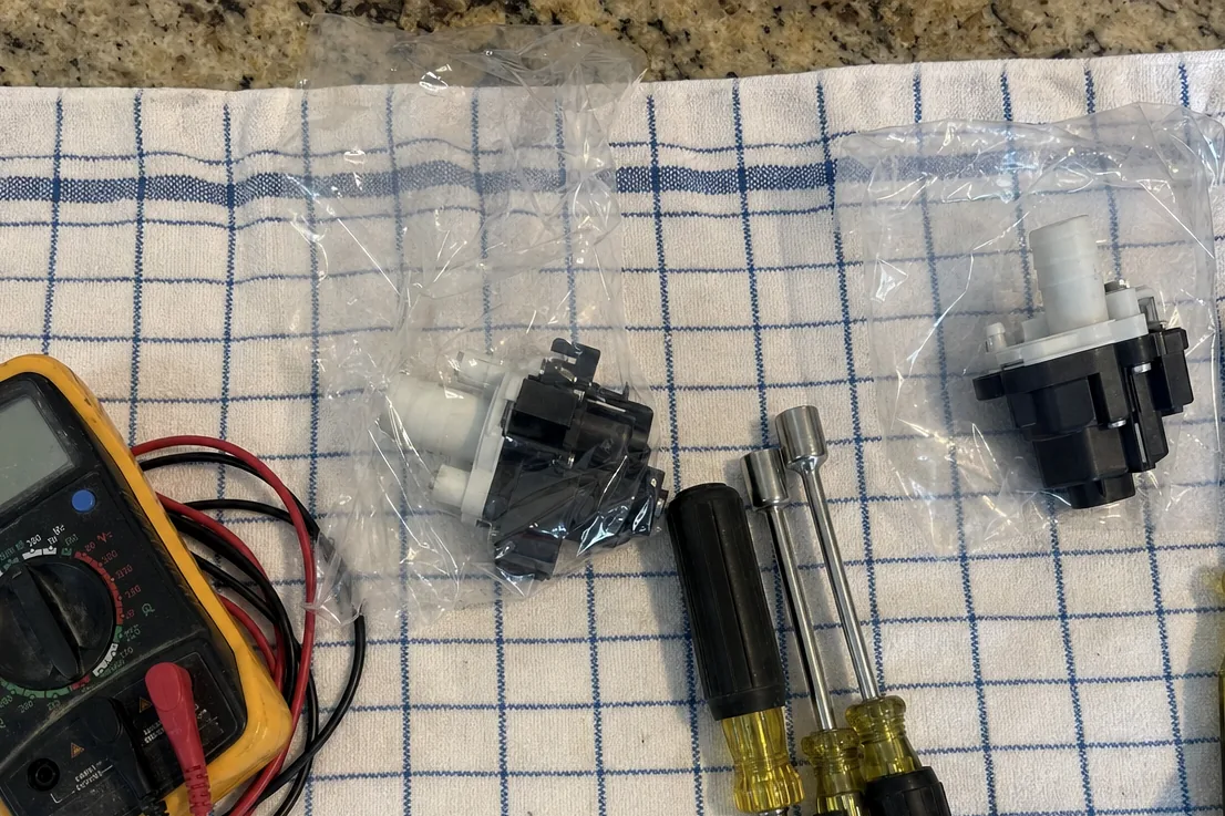 Hand tools and a meter set out in a row on a cloth before a job begins